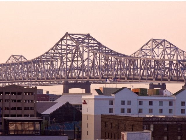 a train bridge over a city with buildings