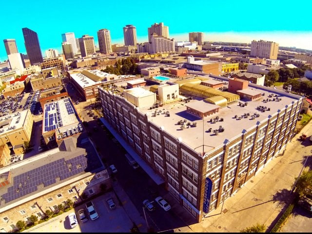an aerial view of a city with buildings and a parking lot