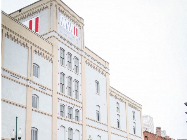 a tall white building with a clock tower on top of it