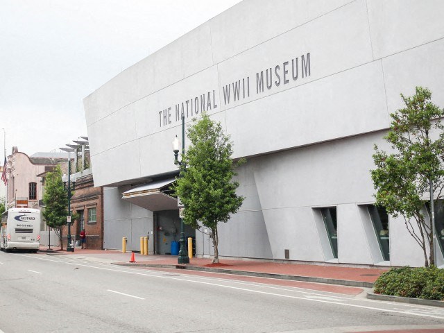 a large white museum building on the side of a street