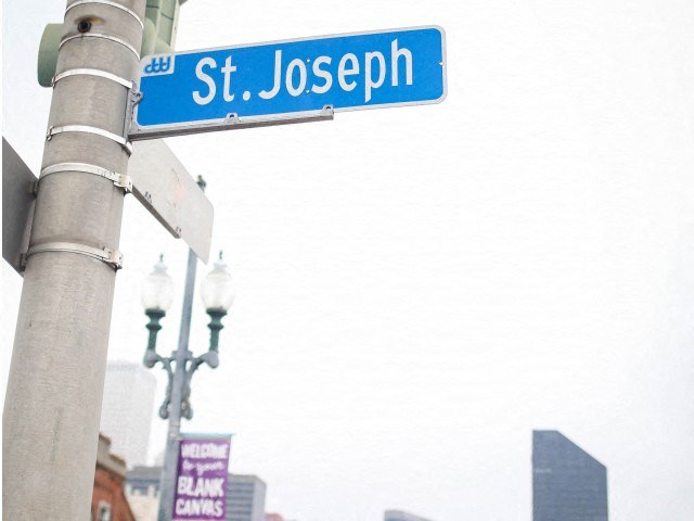 a blue street sign on top of a pole