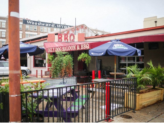 a restaurant with umbrellas and tables outside of it
