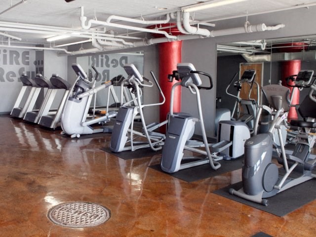 a gym with a bunch of exercise equipment in it