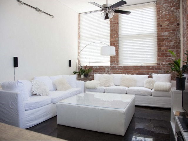 a living room with a white couch and a coffee table