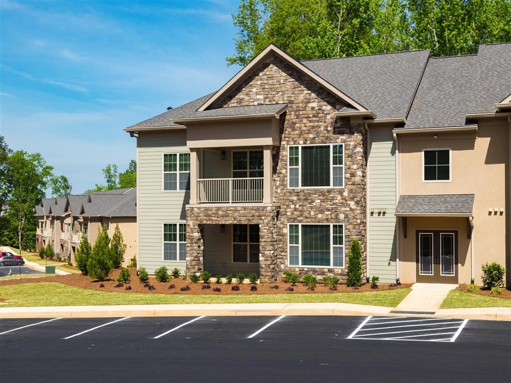 an apartment building with an empty parking lot