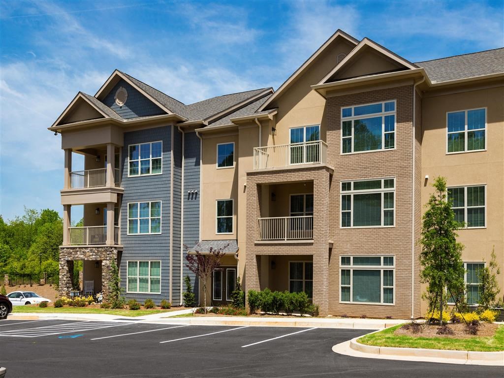 an apartment building with an empty parking lot