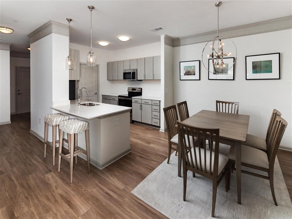 a kitchen and dining room with a table and chairs