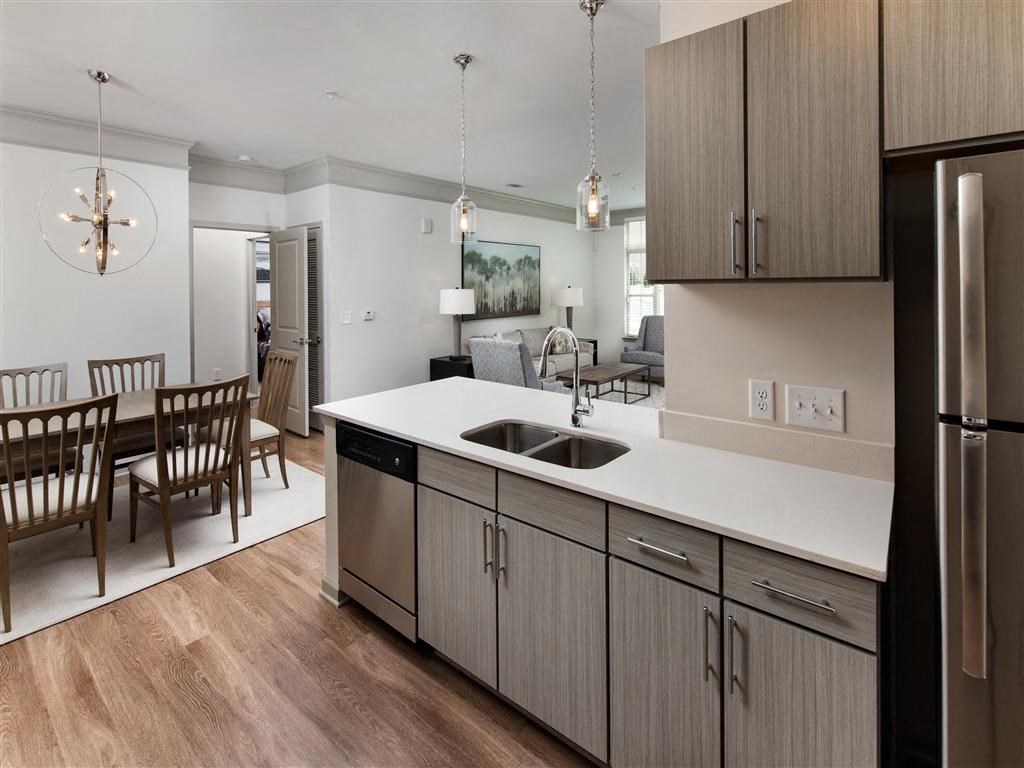 a kitchen and dining room with a table and a refrigerator