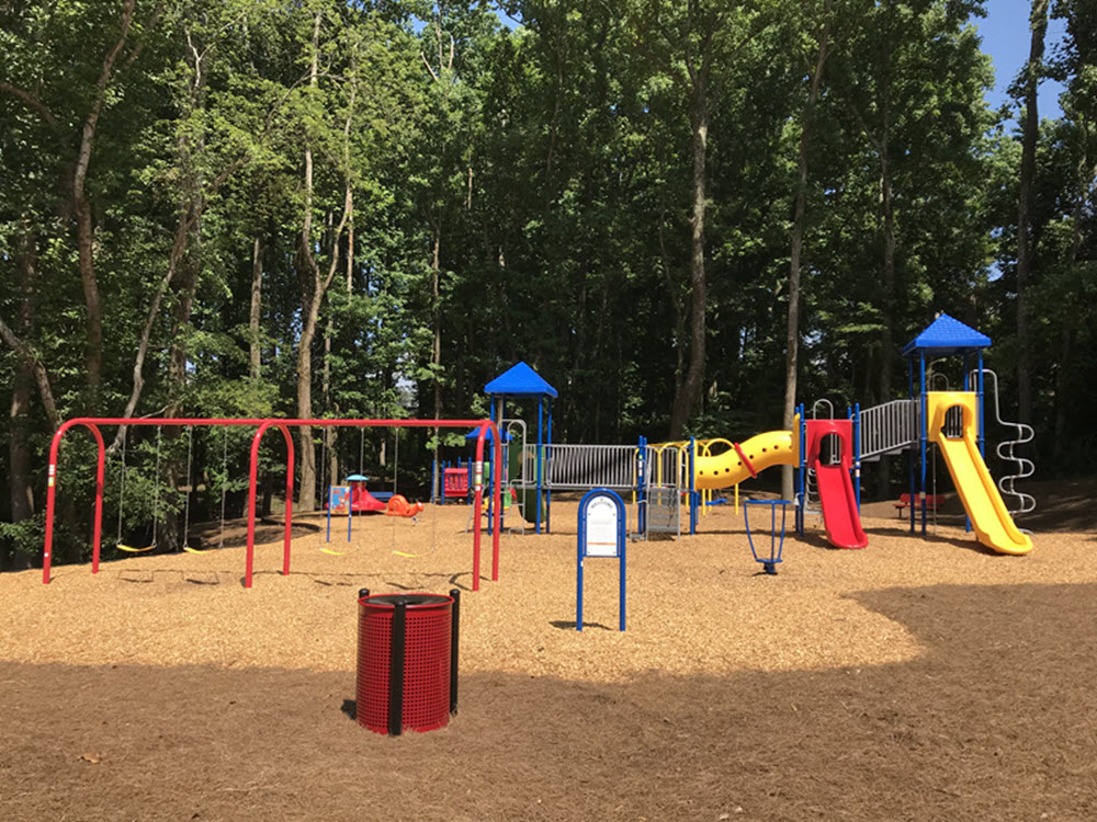 a playground at a park with slides and other toys