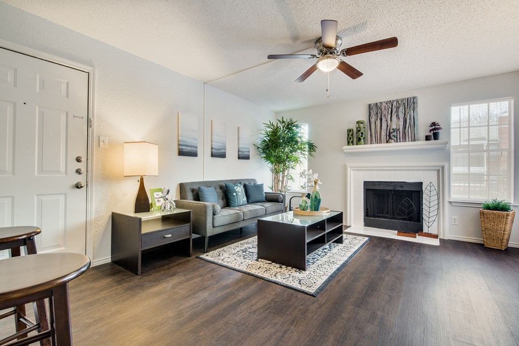 Sophisticated Living Room Remodel With Fireplace at Wildwood Apartments, CLEAR Property Management, Texas, 78752