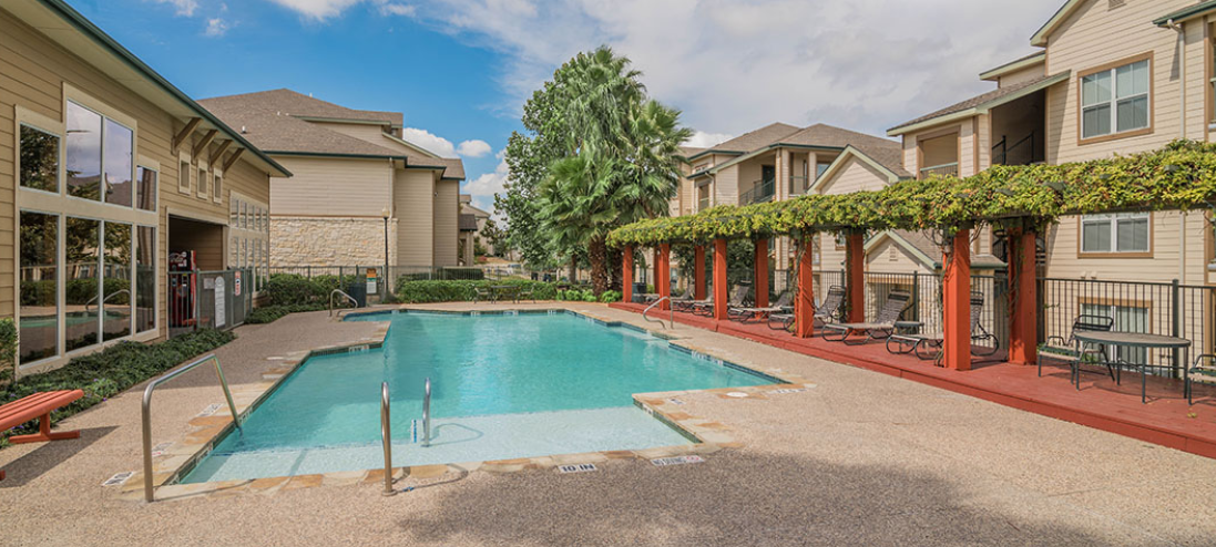clear blue pool with red wood sundeck