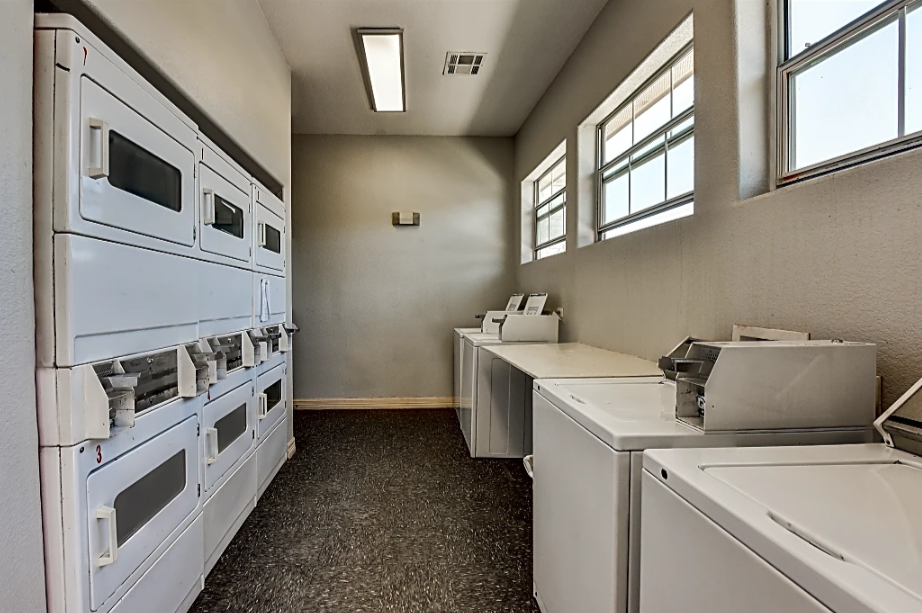 an empty kitchen with stoves and appliances in a room