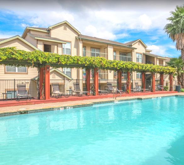 a swimming pool with a building in the background