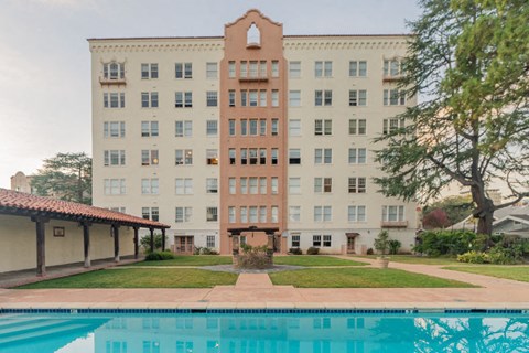 a large building with a pool in front of it