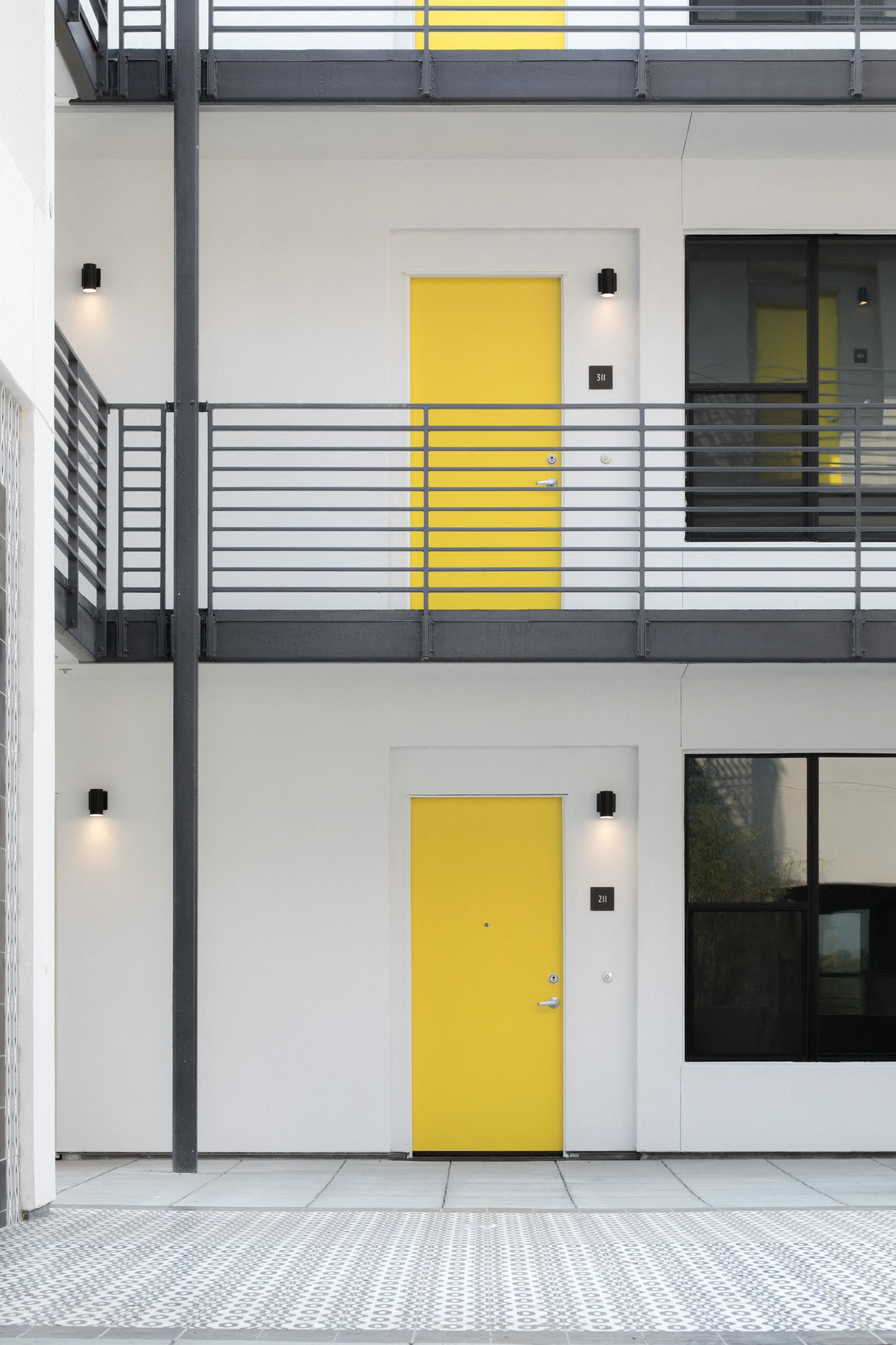 a yellow door in the middle of a white building