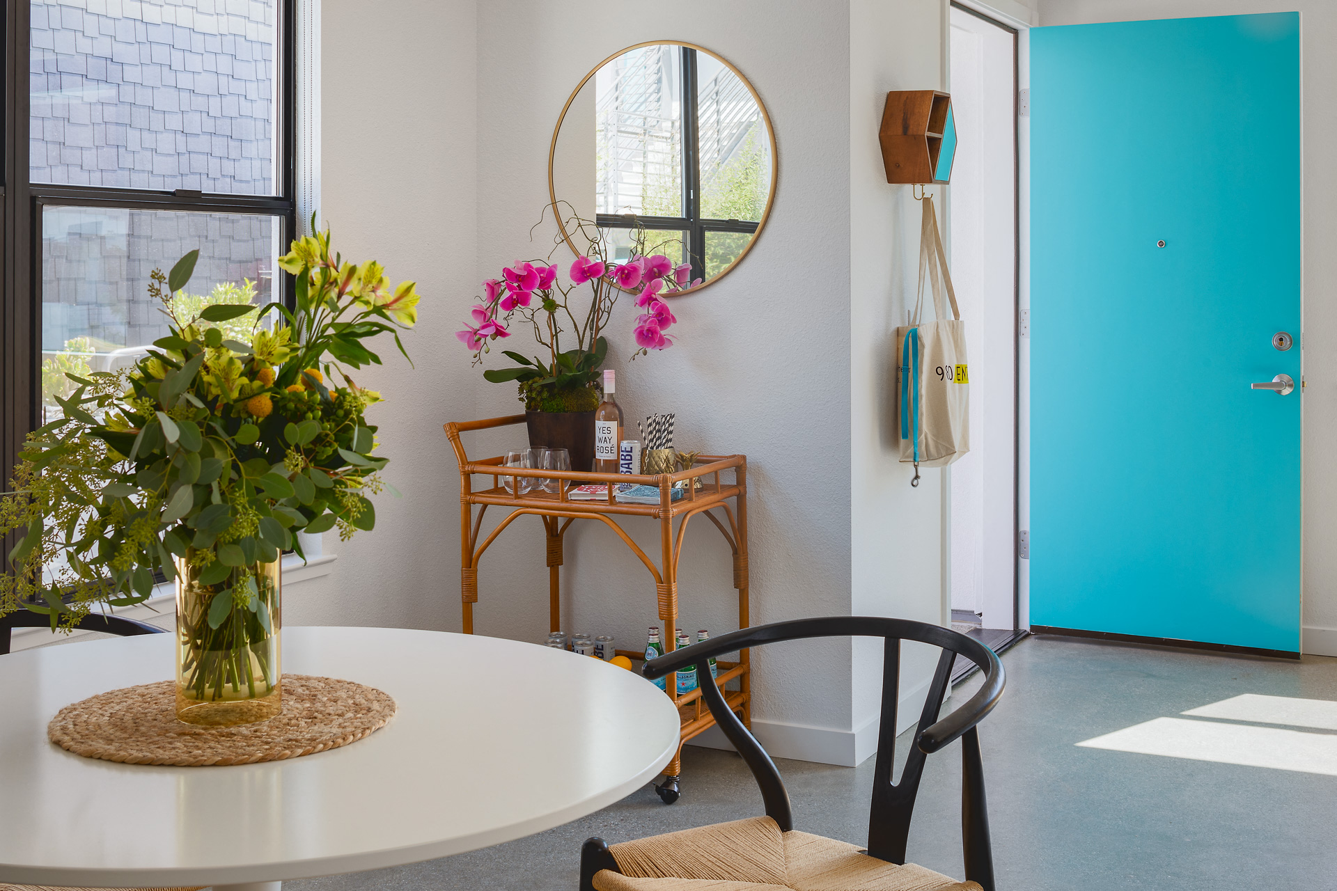 a dining room with a table and a vase of flowers