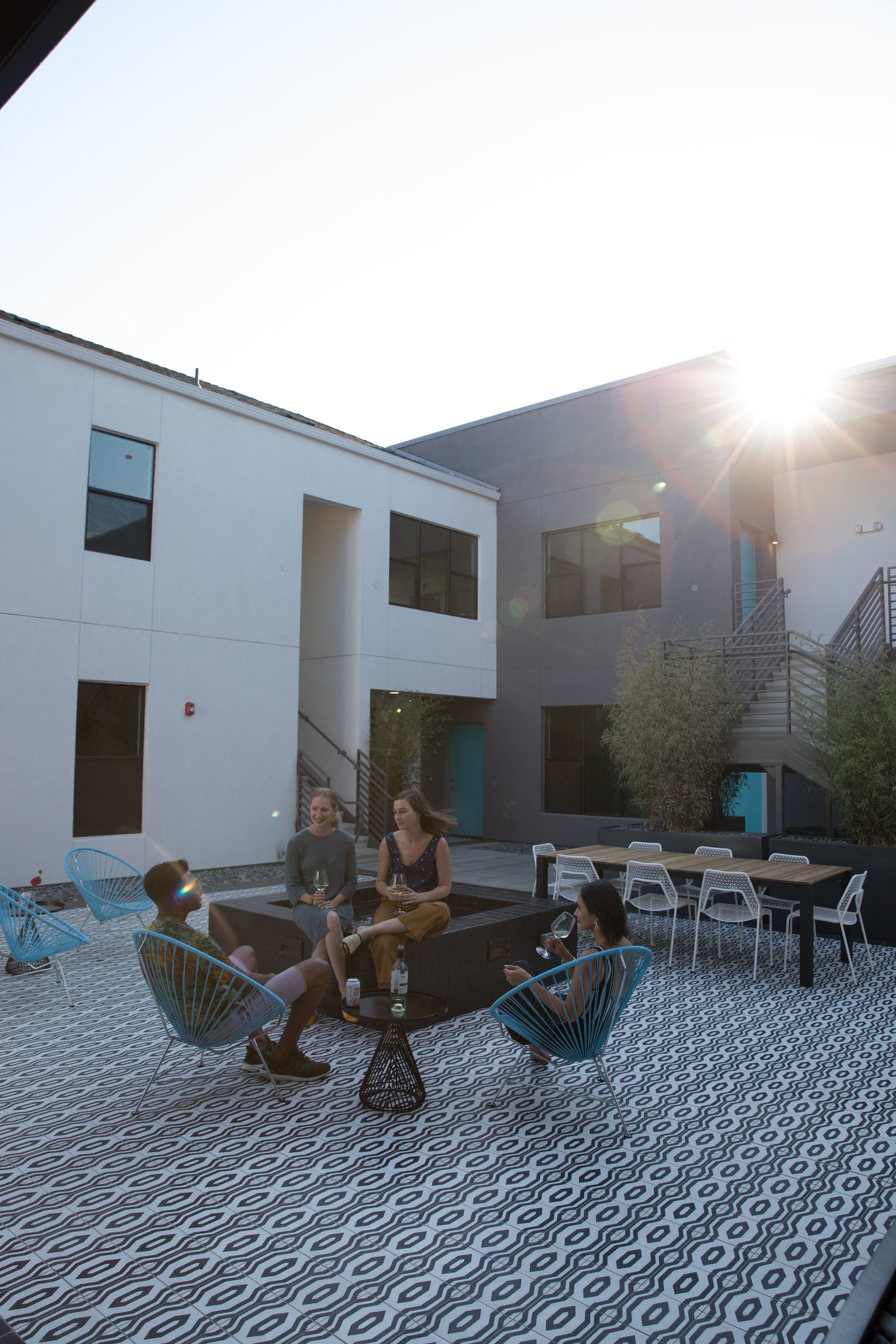 a group of people sitting in chairs outside of a building
