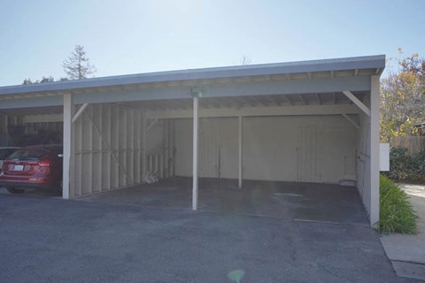 a white garage with a red car parked in it