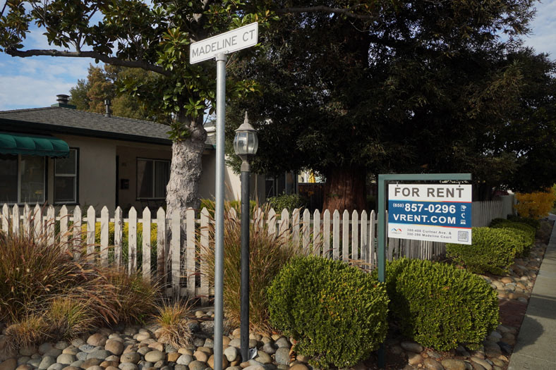 a for rent sign in front of a house