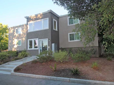 a house with a landscaped yard in front of it
