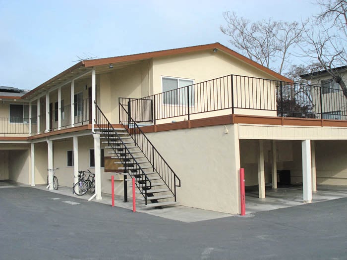 a building with stairs and a bike parked in front of it