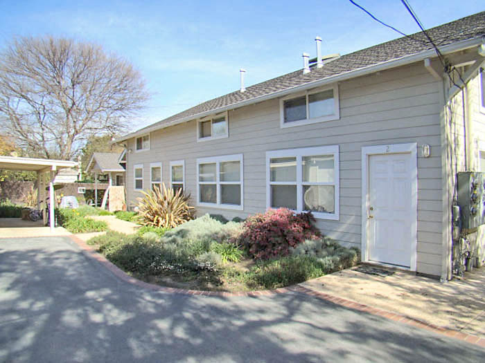 a white house with a white door and a driveway