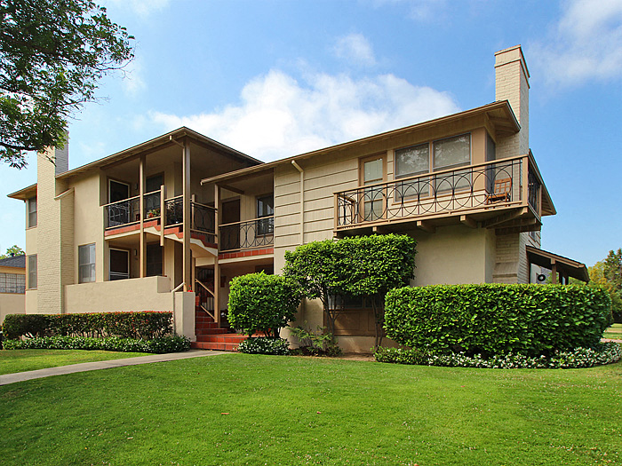 a house with a green lawn in front of it