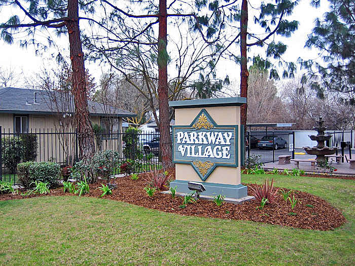 a parkway village sign in front of a house