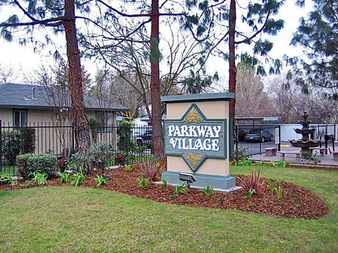 a parkway village sign in front of a house