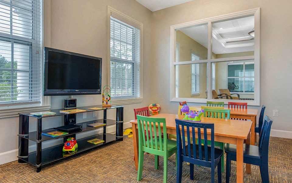 a dining room with a table and chairs and a television