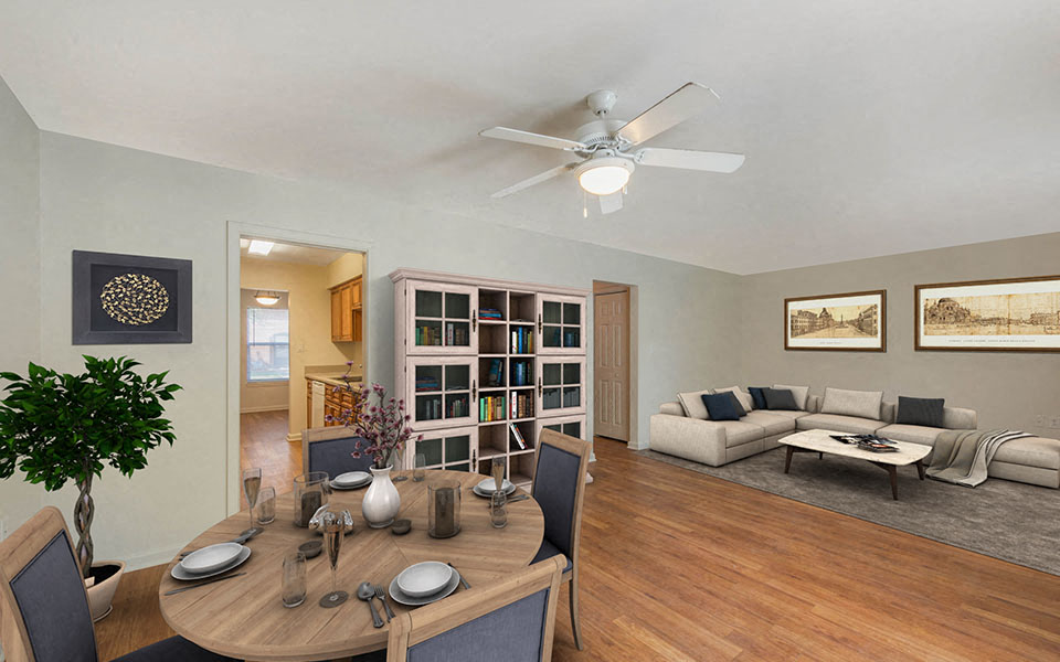 a living room and dining room with a table and a ceiling fan