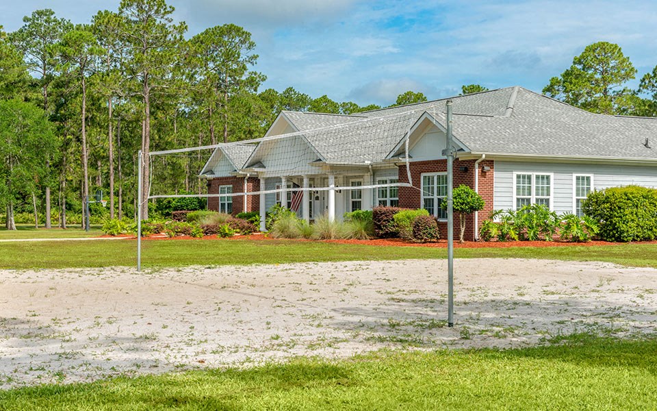 a house with a volleyball court in front of it