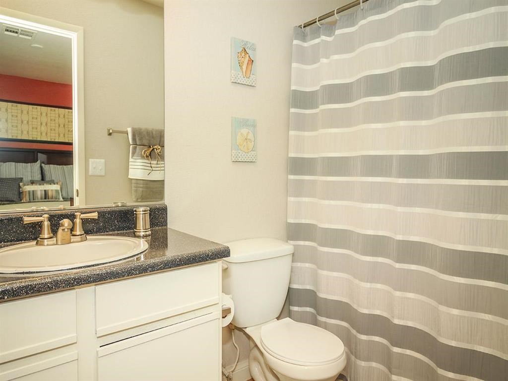 a bathroom with a sink toilet and a shower