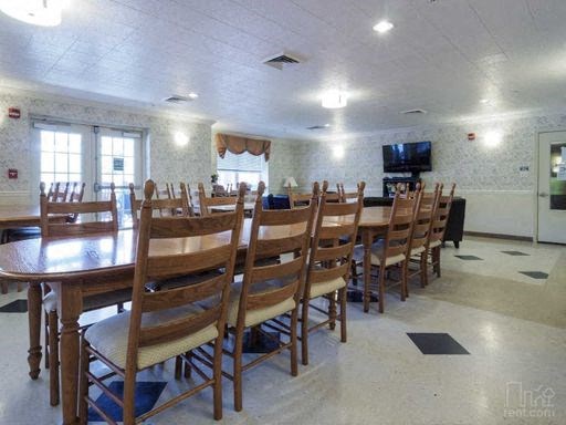 a large dining room with a long table and chairs