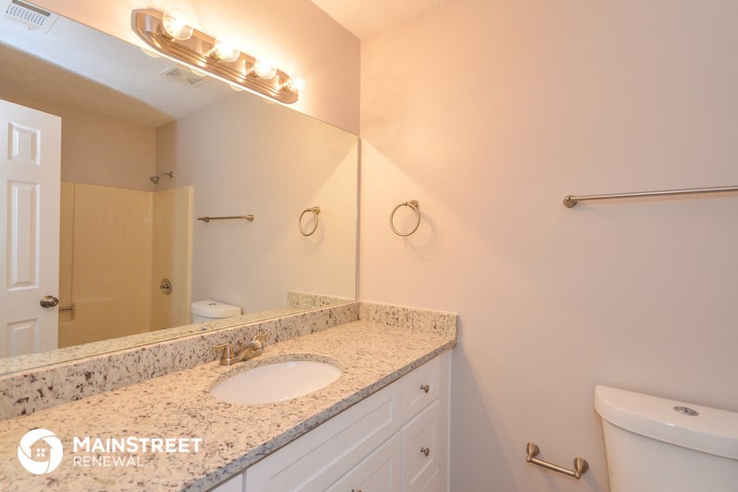 a bathroom with a sink and a mirror and a toilet