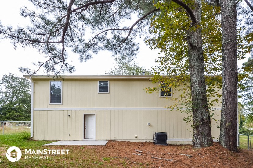a small house with two trees in front of it