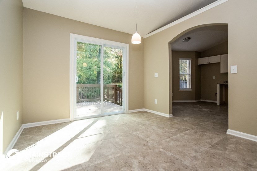 an empty living room with a sliding glass door