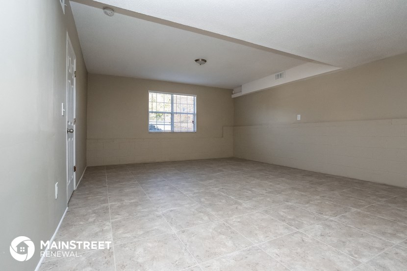 an empty room with a door and a window