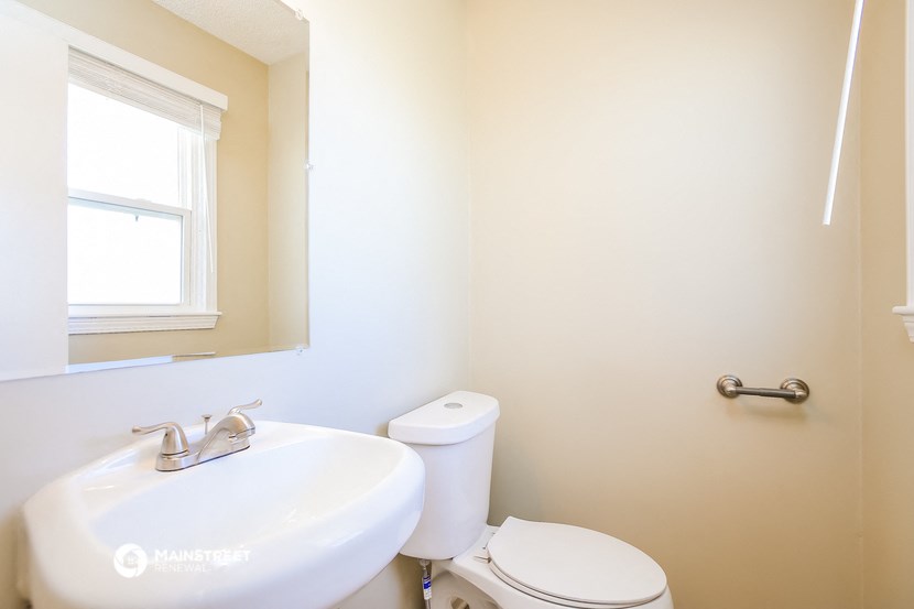 a bathroom with a sink and a toilet and a mirror