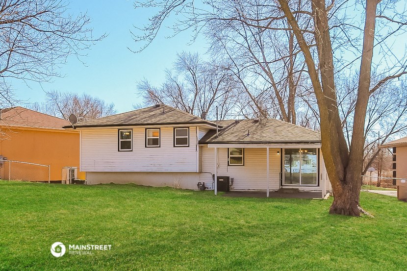 a white house with an orange house behind it
