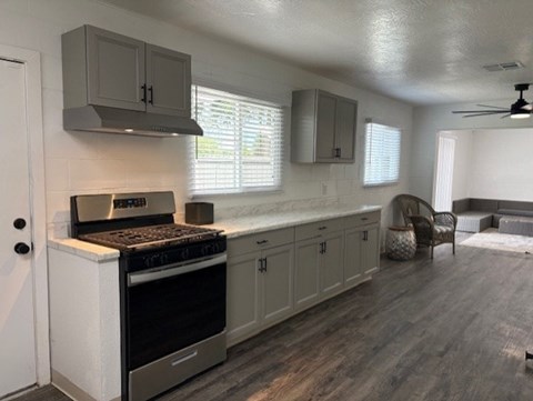 A kitchen with a stove and cabinets.