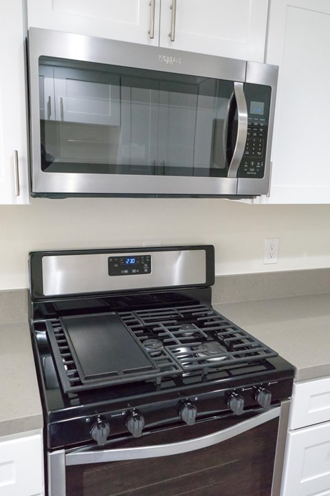 a kitchen stove with a microwave above it