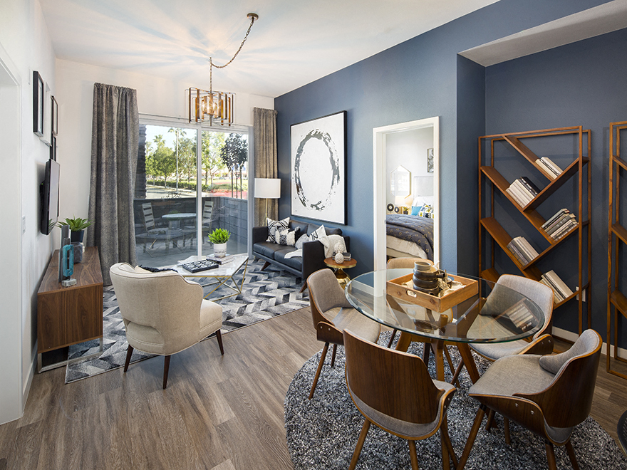 A modern living room with a glass table and chairs.