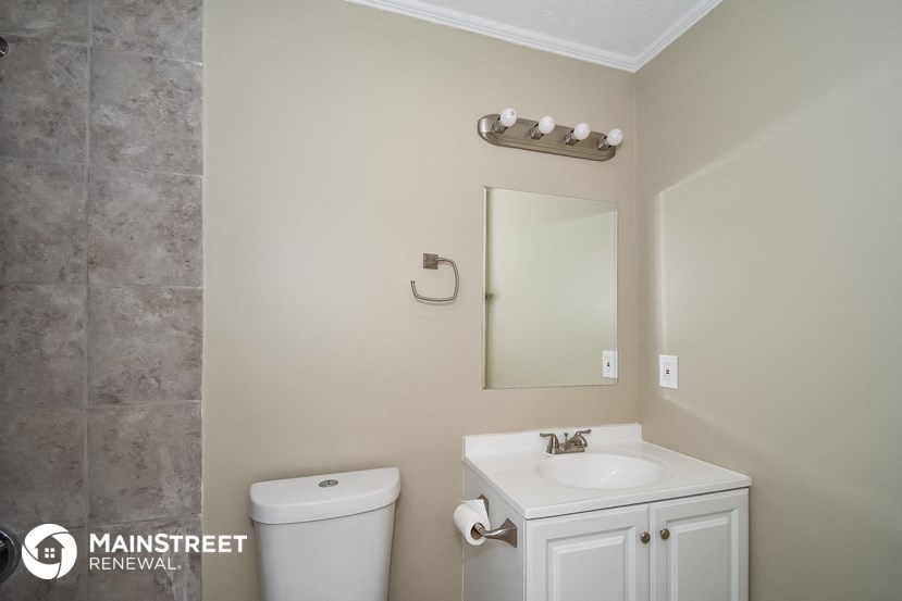 a bathroom with a sink and a mirror and a toilet