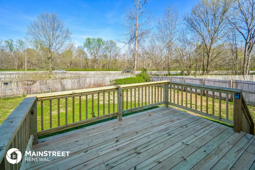 a backyard with a deck overlooking a pond