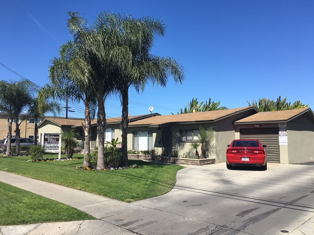 a house with a red car parked in front of it