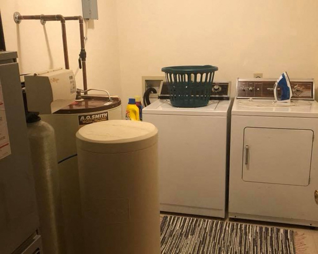 a kitchen with two washing machines and a refrigerator