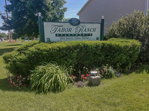 a sign is in the front of a garden