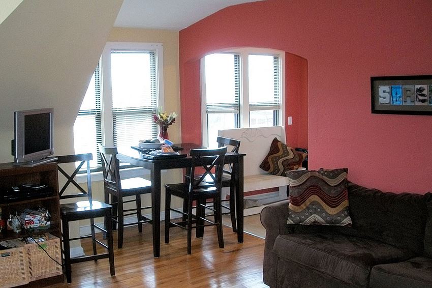 a living room with a dining room table and chairs