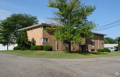 A large house with a driveway in front of it.